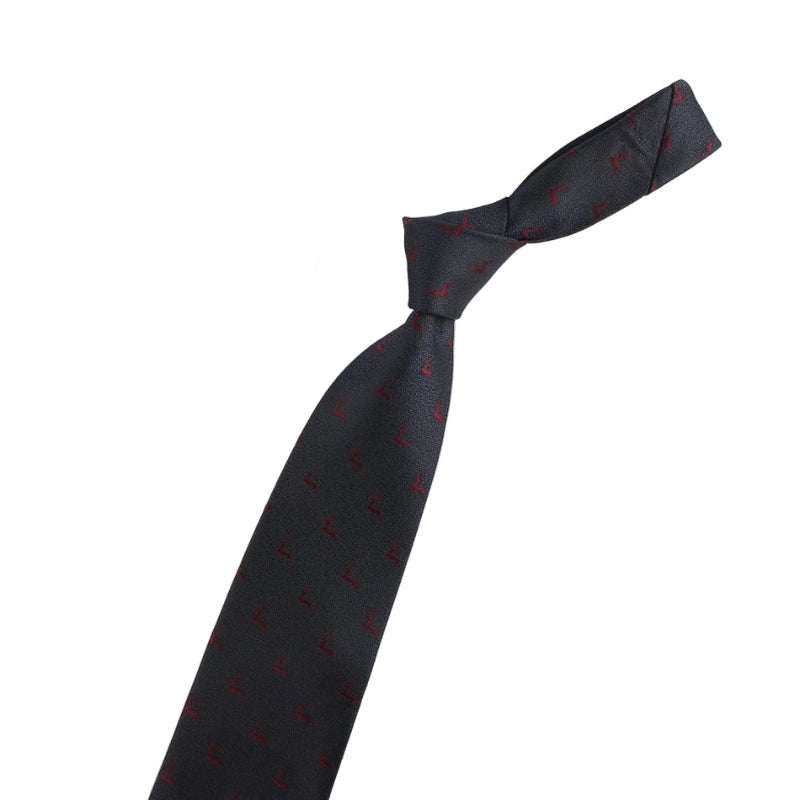 Black tie with red pattern and two decorative pins on a white background