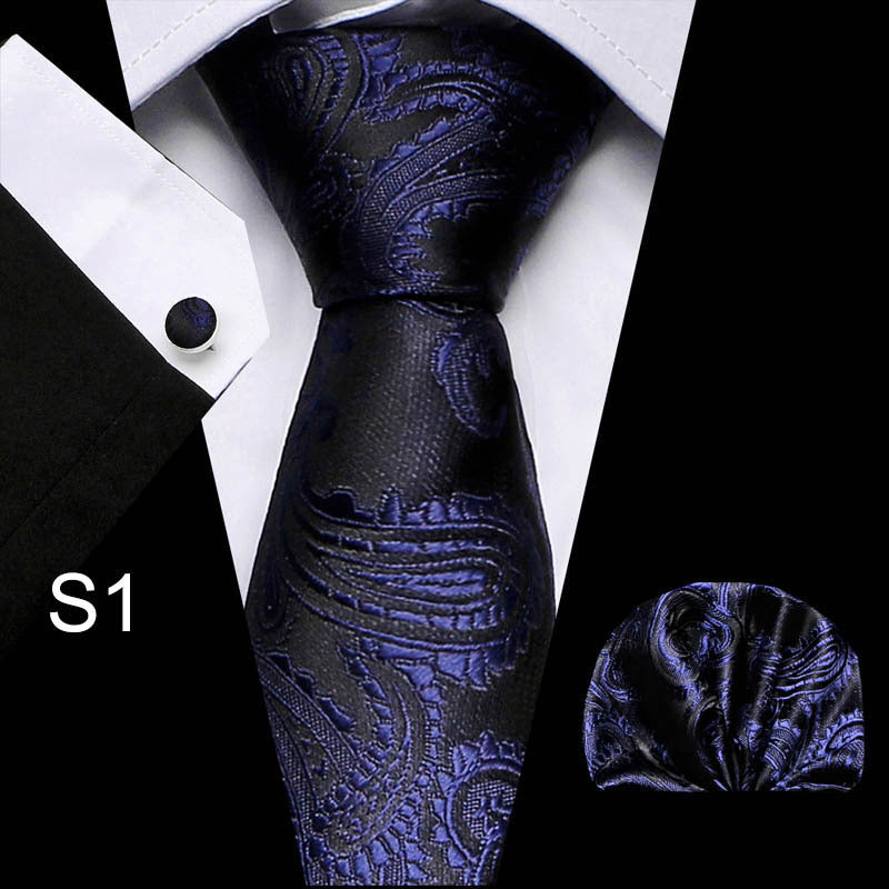 Business tie in dark navy with textured pattern and matching pocket square.