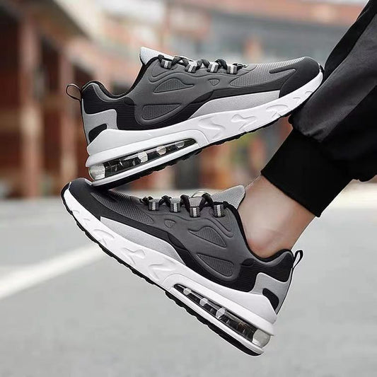 Black and gray sneakers with air cushioning on a blurred street background