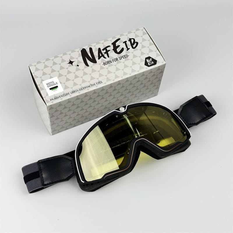 Sporty motorcycle goggles with black frame and olive tinted lens, wide face strap