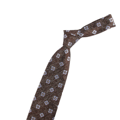 Brown patterned tie with a small violin-shaped object on a white background