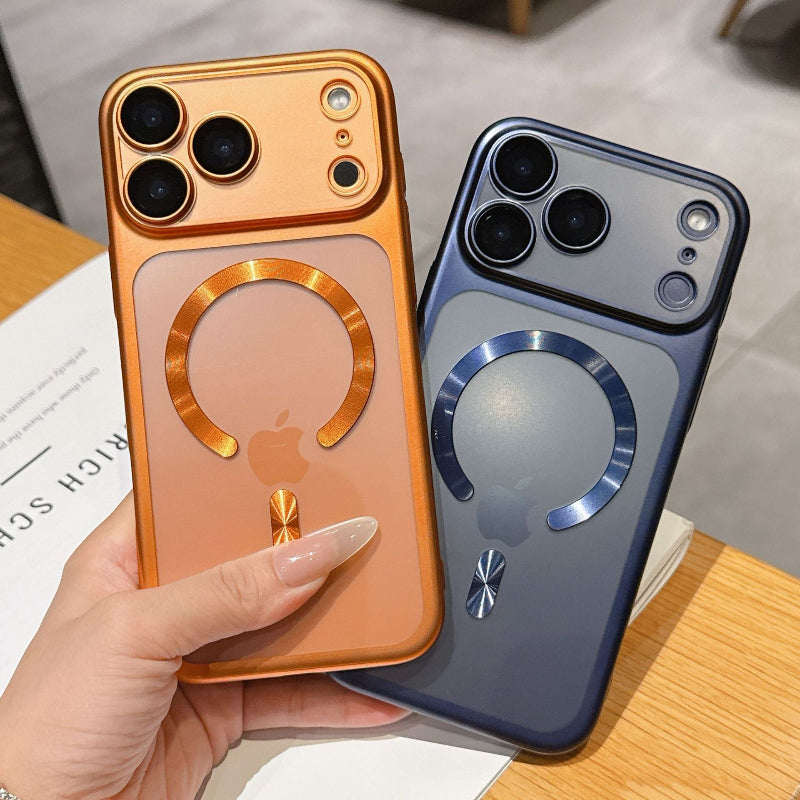 Two phone cases, one gold and one blue, held by a hand on a wooden surface.
