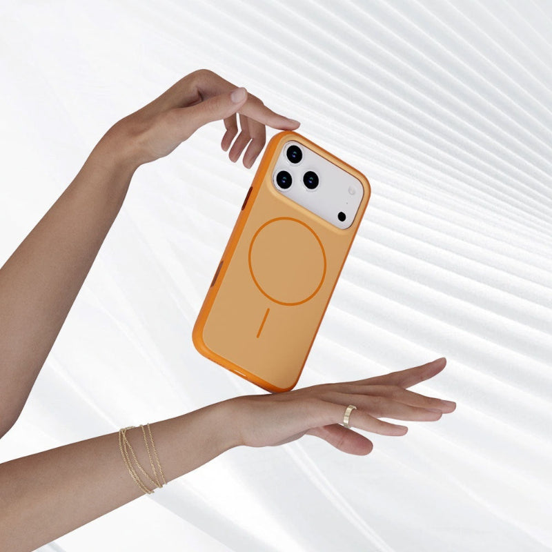 Orange phone case with magnetic design held by a hand against a white background