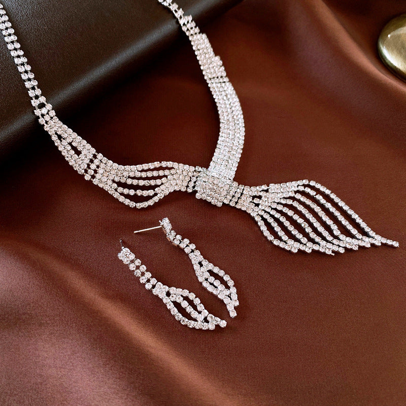 Silver-tone rhinestone choker necklace with leaf drop pendant and earring set