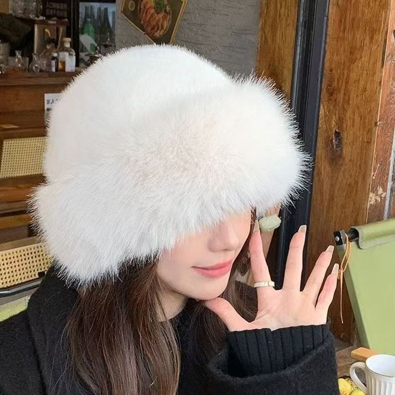 Person wearing a fluffy white hat indoors