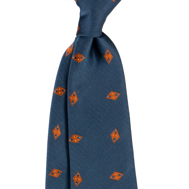 Blue necktie with orange diamond and geometric emblem pattern