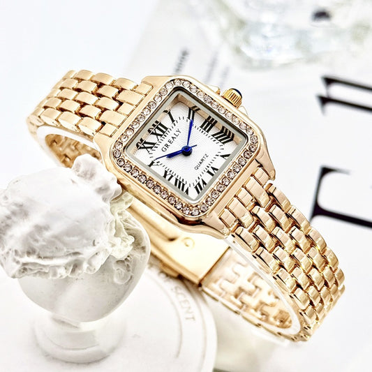 Gold wristwatch with a white face and Roman numerals on a decorative background