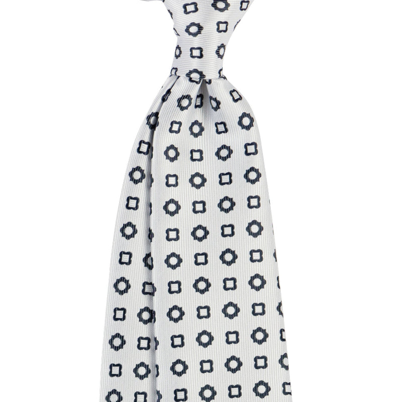 White necktie with navy square-link geometric pattern