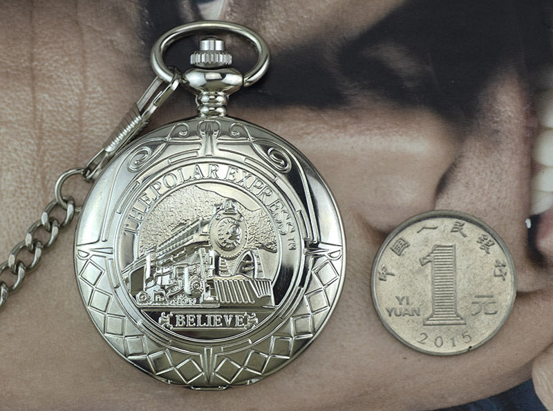 Silver pocket watch next to a Chinese yuan coin on a person's hand