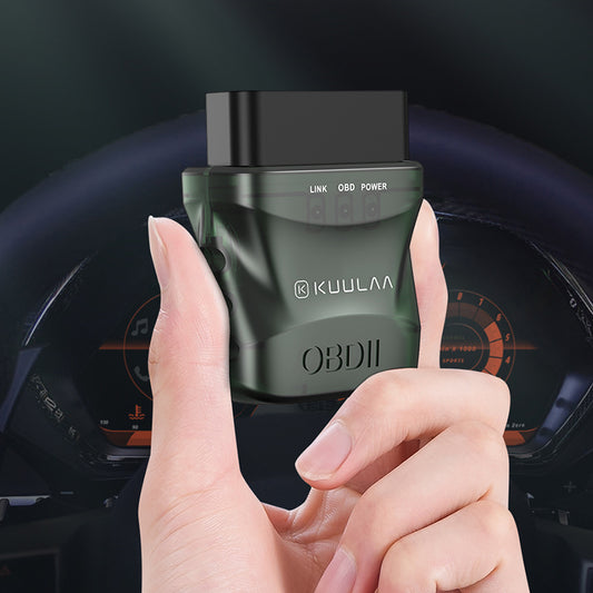 Kuulaa OBDII diagnostic tool held in a hand with a car dashboard in the background. YAXSO STORE 