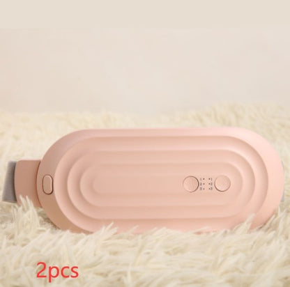 Pink electric waist massager belt with gray strap on soft fabric, front panel visible.