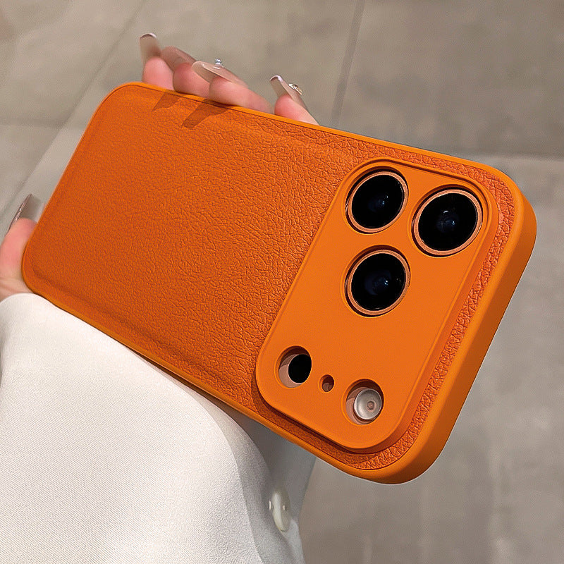 Orange phone case held by a person with a neutral background