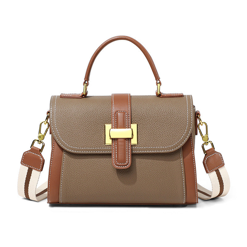 Women’s flap leather handbag on white with top handles, crossbody strap, and gold buckle hardware