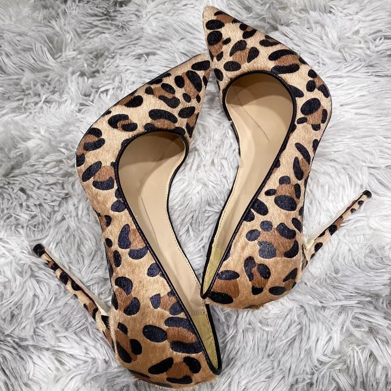 Leopard print high heels on a white fluffy surface