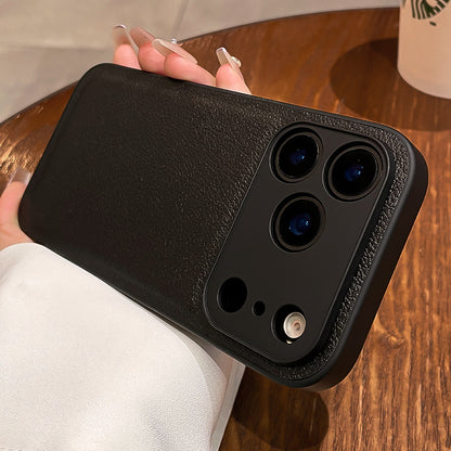 Black phone case held by a person on a wooden table