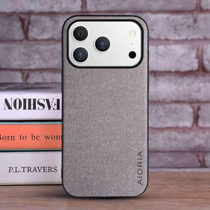 Gray phone case with 'Alorva' branding on a brick wall background