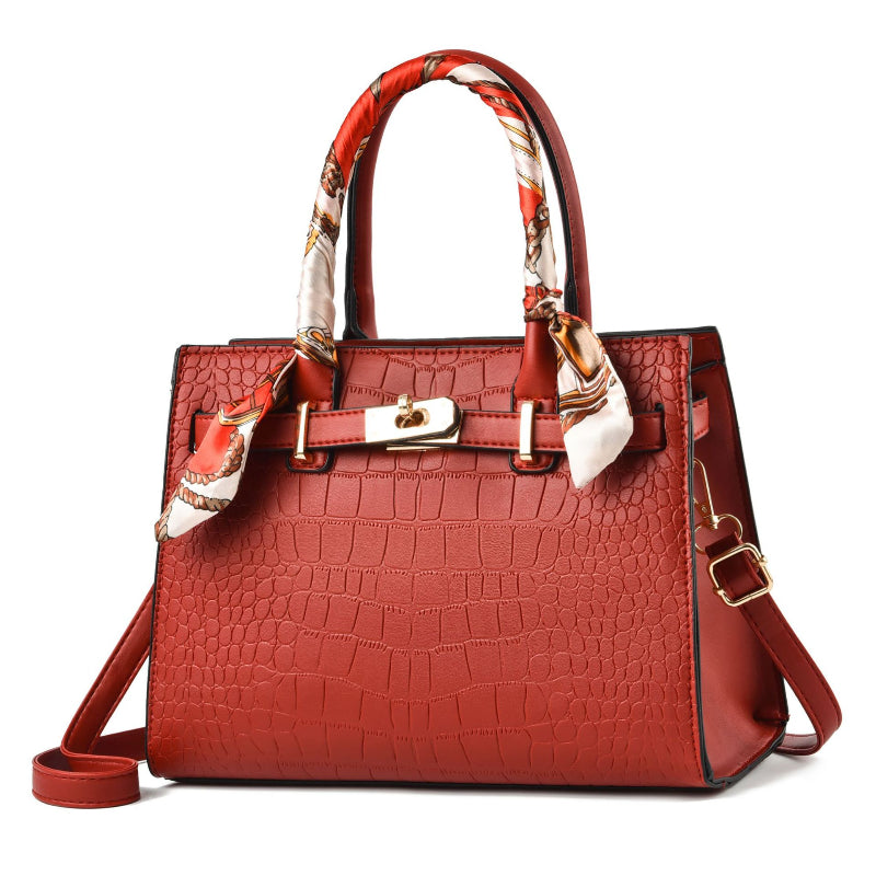 Wine-red croc-textured tote bag with scarf handles and adjustable shoulder strap