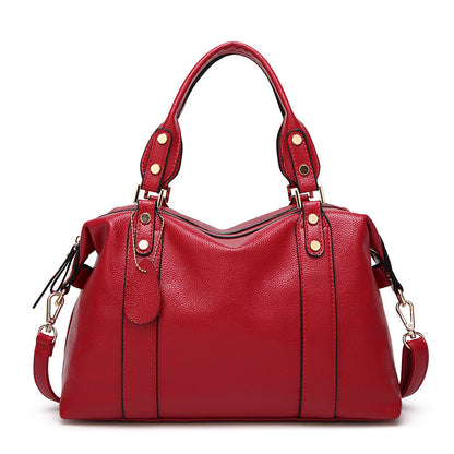 Red PU leather tote handbag with twin top handles and side shoulder strap hardware