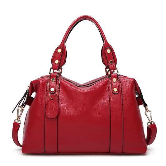 Red handbag with gold accents on a white background