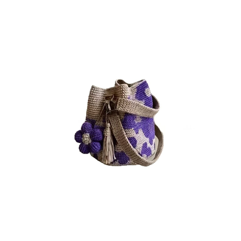 Hand-crocheted tote bag with purple pattern, small purple flower appliques, and tassel