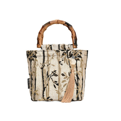 Tote bag with bamboo handle and leaf pattern on a white background