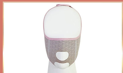 Face-shaping sleep mask on a display, with an open eye area and nose and mouth openings