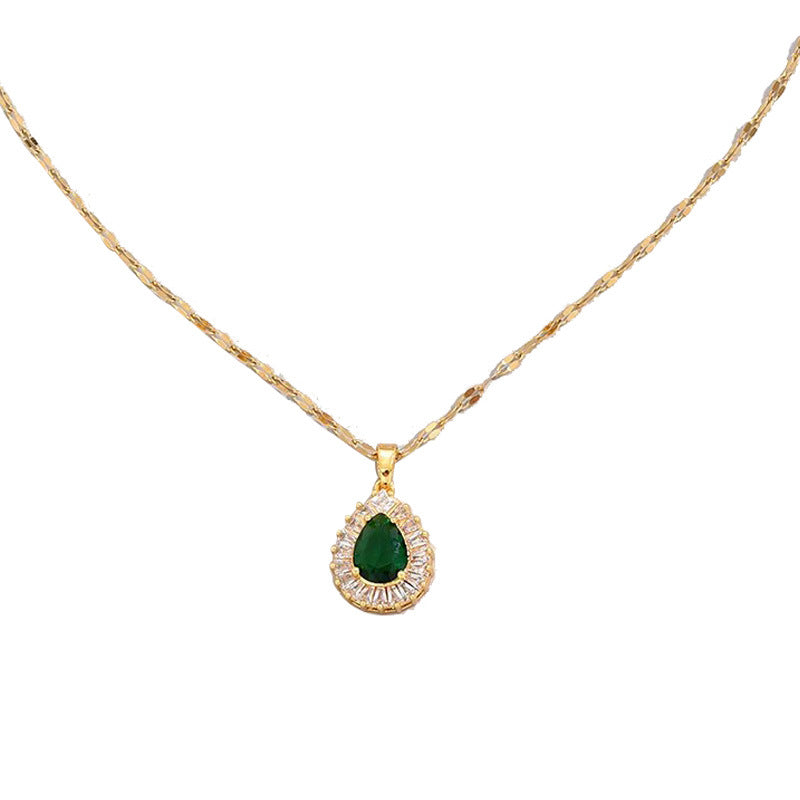 Gold-tone chain with jade green teardrop pendant framed by crystal halo
