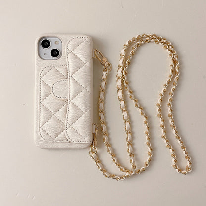 Quilted phone case with gold chain on a beige background