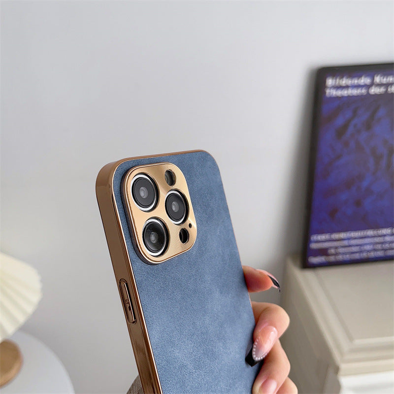 Person holding a phone with a blue case against a neutral background