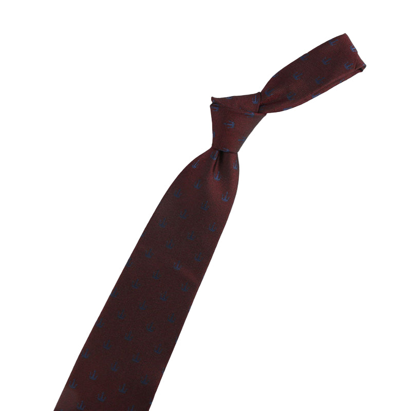 Brown tie with blue patterns, violin-shaped pin, and decorative pin on a white background