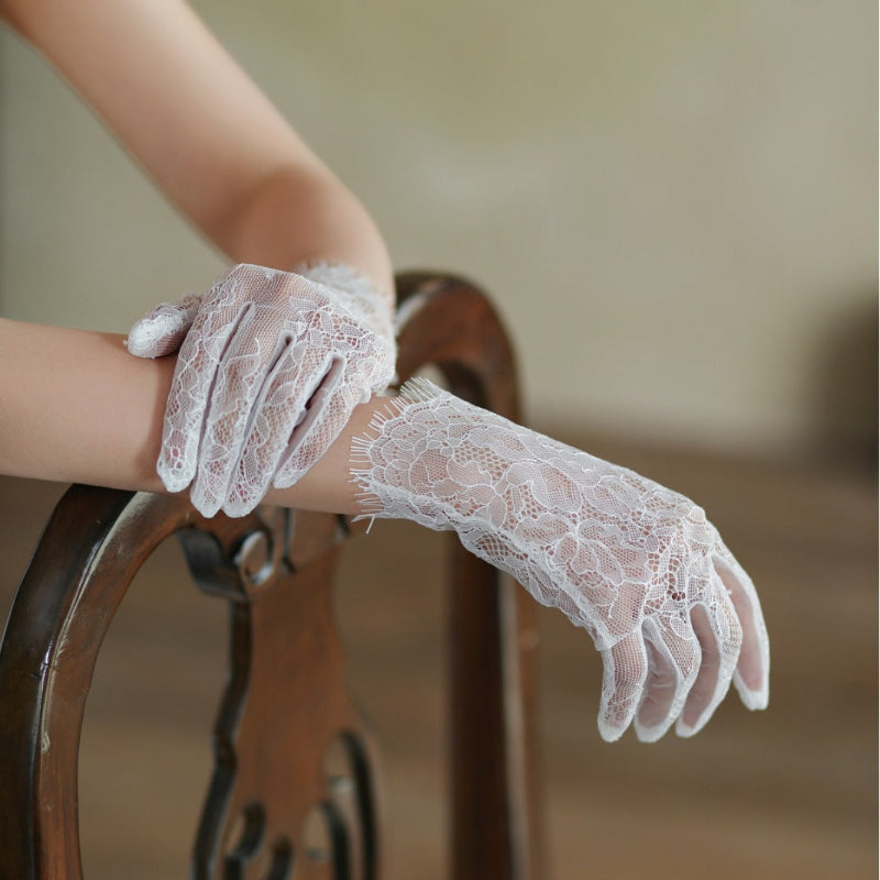 White lace tulle bridal gloves showing full hand coverage, long sheer floral lace cuff