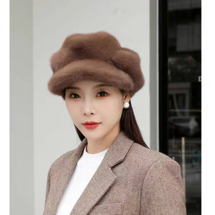 Woman wearing a brown fur hat and coat against a light background