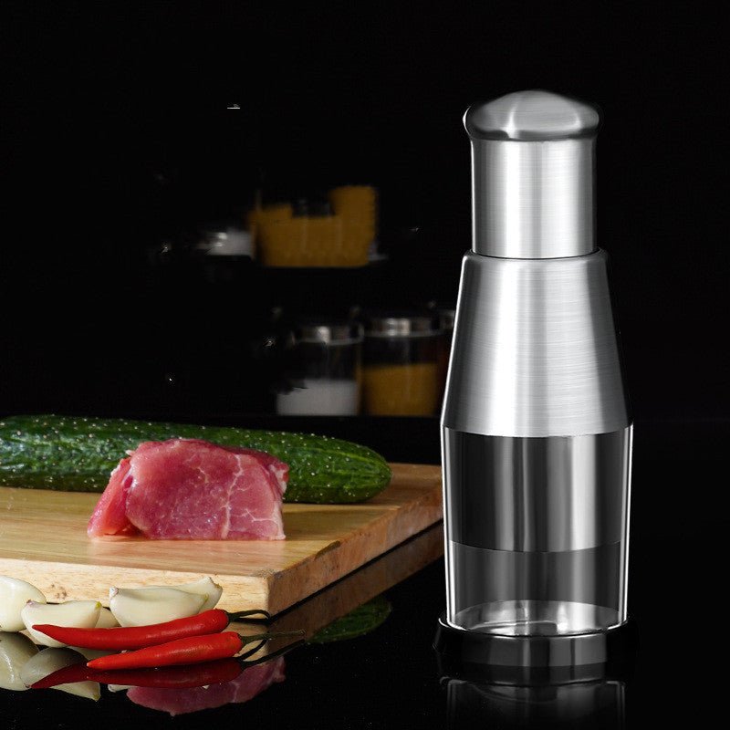 Manual garlic and vegetable chopper with stainless steel top and clear collection cup