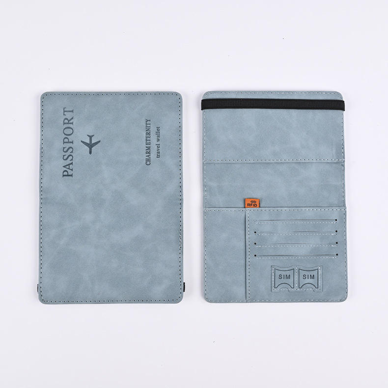 Light blue leather passport cover shown open, with card slots, SIM pockets, and an elastic band.