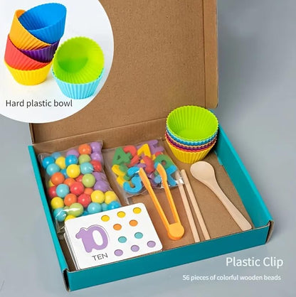 Math learning set in an open box with counters, numbered cards, bowls and sorting tools
