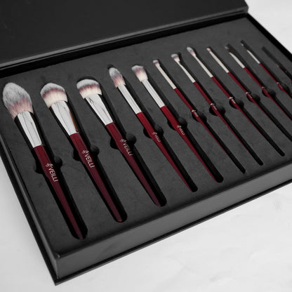Twelve makeup brushes arranged in a fitted black case