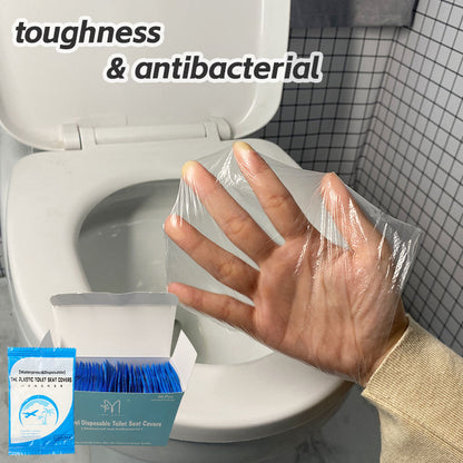 Clear disposable toilet seat cover held above a toilet, with a packet and open box.