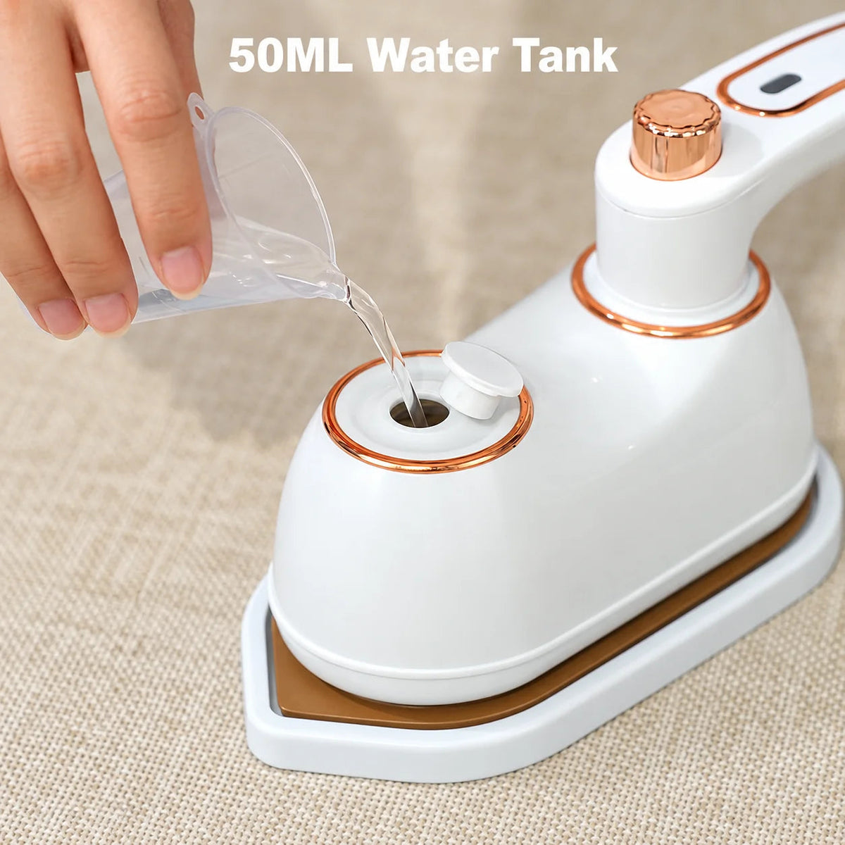 Portable folding clothes iron with open water tank being filled