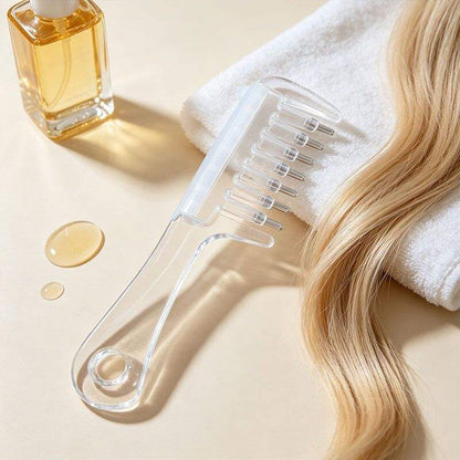 Clear hair oil applicator comb with long handle, liquid reservoir, and metal-tipped teeth.