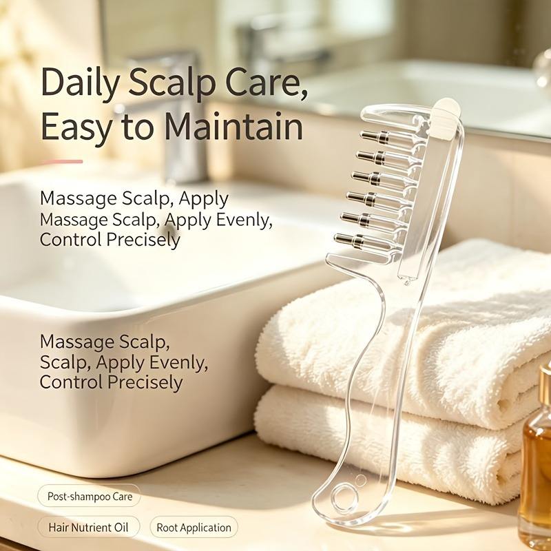 Clear scalp massage and liquid applicator comb with metal-tipped rollers and a long handle.