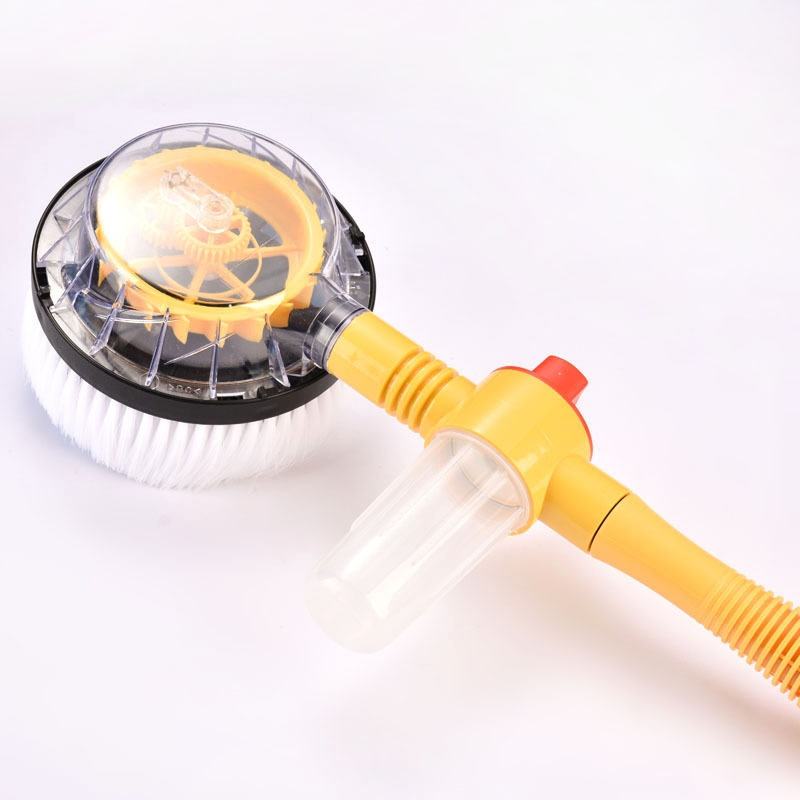Rotating car wash brush with white bristles, clear soap reservoir, and yellow handle