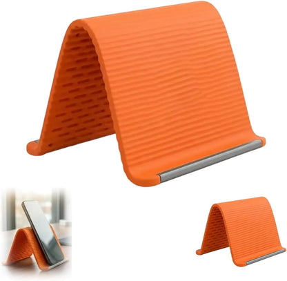 Orange foldable silicone phone stand with ribbed surface and silver support lip.