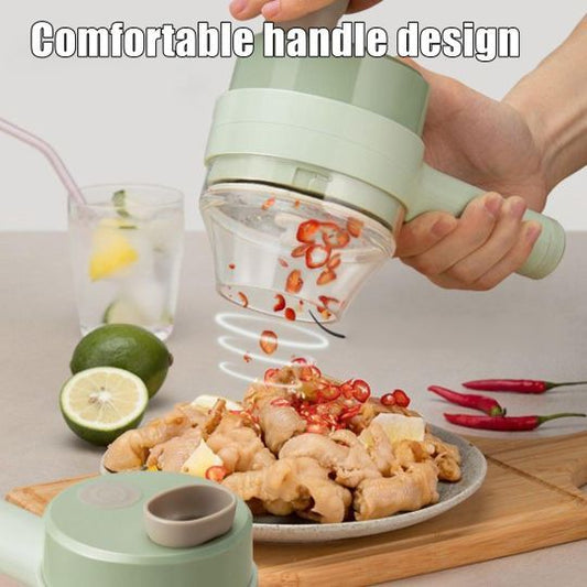 Mini food chopper with green lid and transparent container, held while chopping vegetables