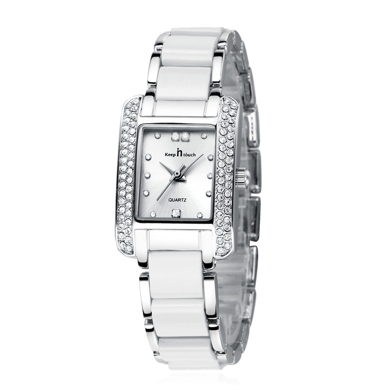 Silver square quartz watch with rhinestone bezel and white ceramic link band
