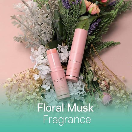 KAHI pink balm stick tubes with floral musk theme, shown with bundled flowers