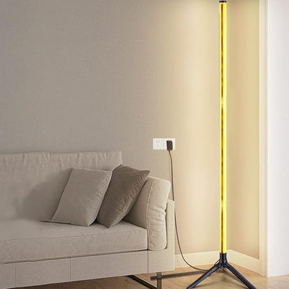 Slim LED floor lamp with a warm yellow light bar and three-legged base.