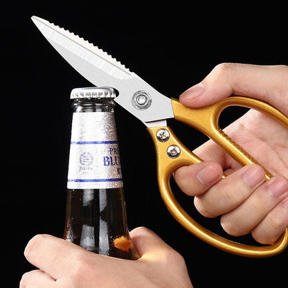 Gold-handled kitchen scissors used to pry off a bottle cap.
