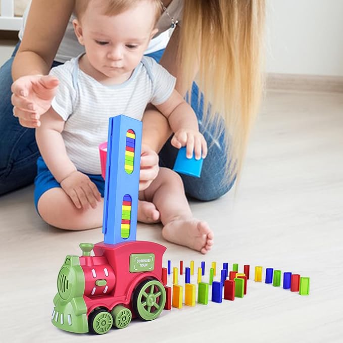 Automatic domino train set with red and green locomotive, blue loader, and upright colorful dominoes