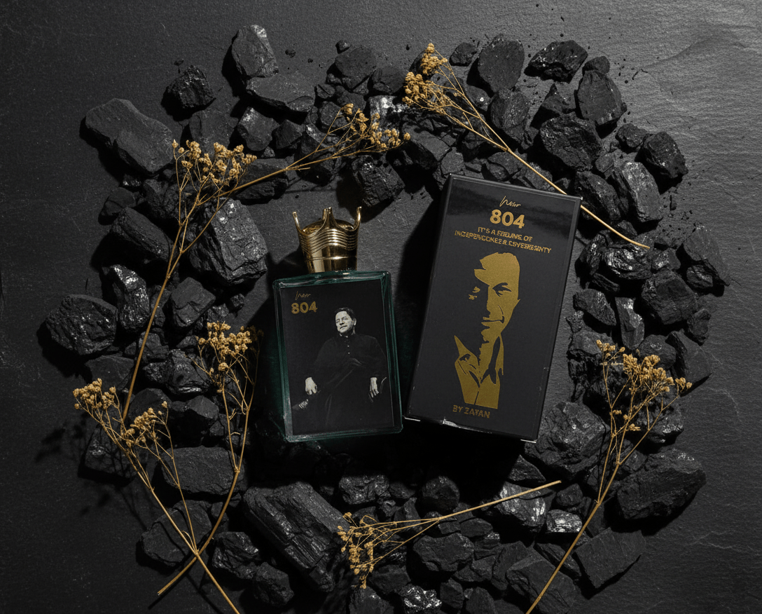 804 Imran perfume in a green glass bottle with a crown-shaped cap beside its black box.