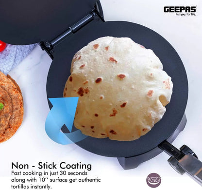 Open electric roti maker cooking a puffed flatbread on its black nonstick plate
